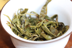 tea leaves brewed in a white gaiwan